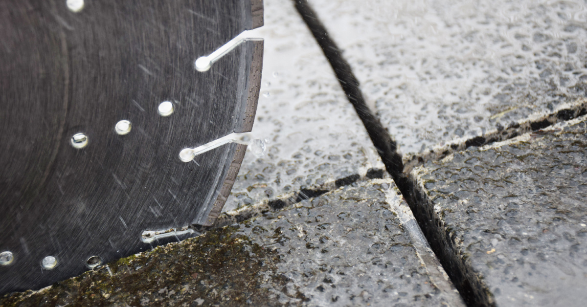 Close up showing a concrete road saw cutter blade cutting